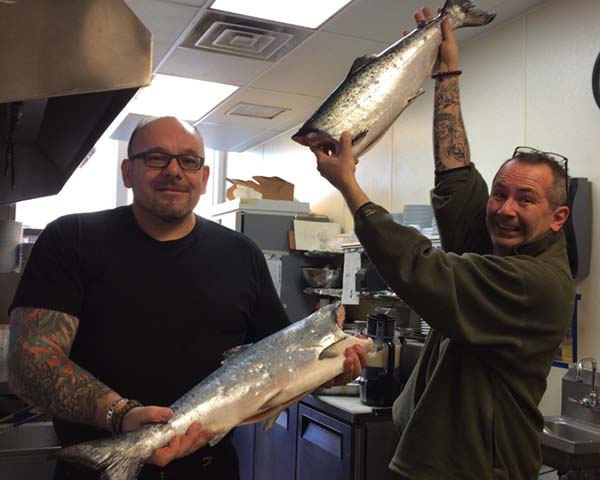 happy customers holding up their nerka salmon